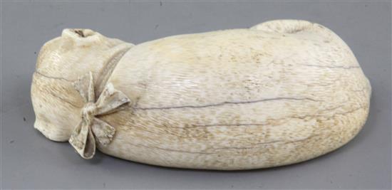 An early 19th century Dieppe carved ivory model of a sleeping Pug dog, 4.5in.